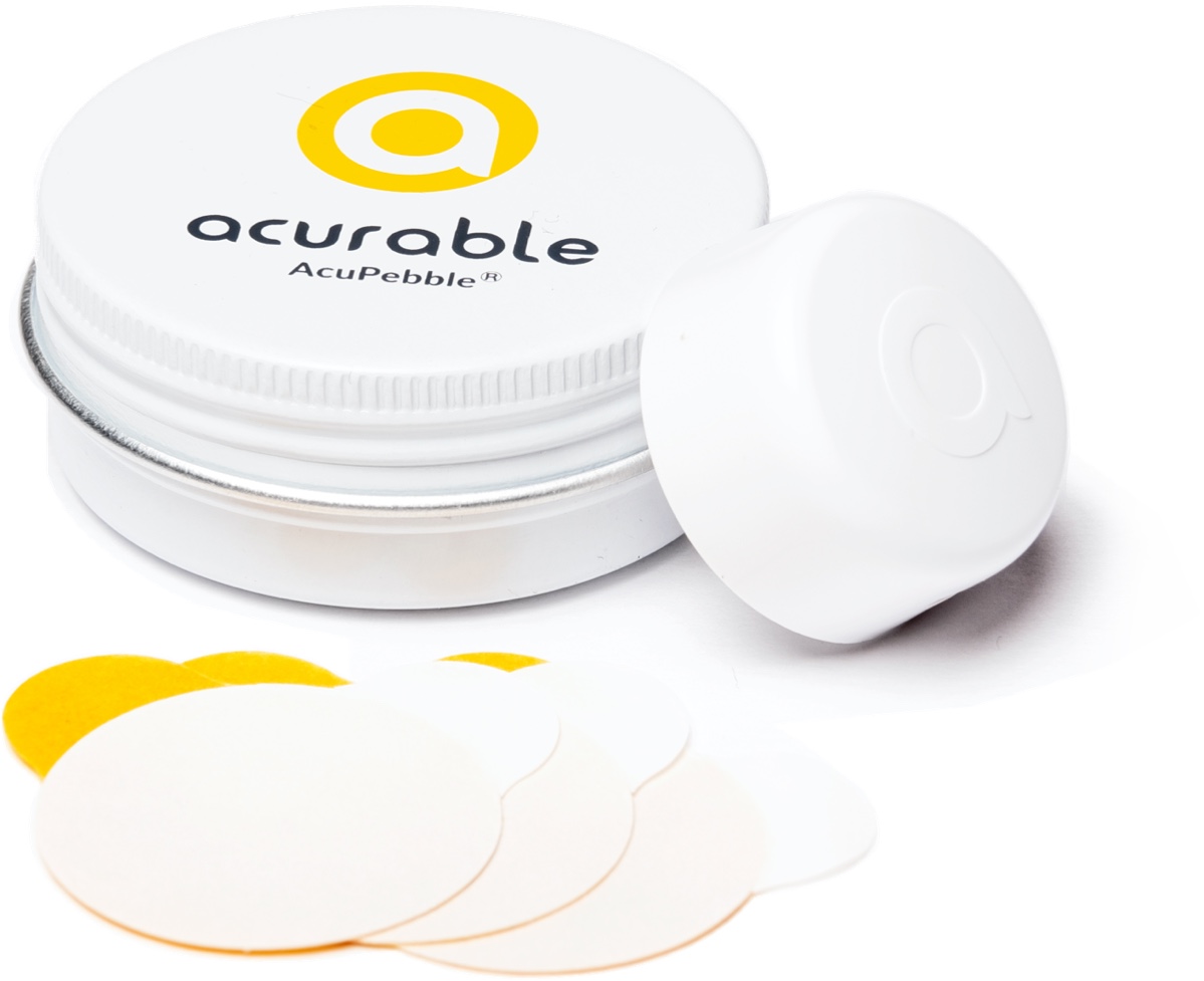 The small, reusable AcuPebble sleep sensor with its storage tin and adhesive pads